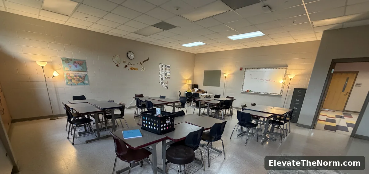 A high school classroom lit by floor lamps rather than overhead fluorescents, with tables grouped in pairs and open floor space for the teacher to circulate.